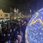 street with crowds looking at Christmas lights